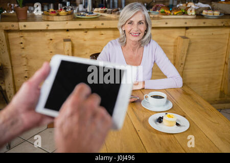Hands of waiter using digital tablet in cafÃƒÂ© Stock Photo