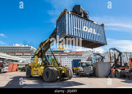 Victoria, Mahe, Seychelles - December 16, 2015: Forklift handling container box loading at dockyard in Victoria port, Mahe island, Seychelles. Stock Photo