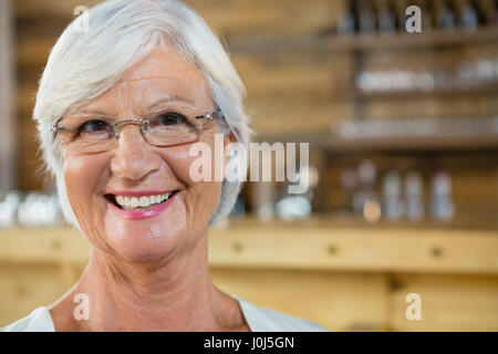 Portrait of smiling senior woman in cafÃƒÂ© Stock Photo