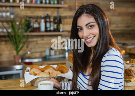 Portrait of woman having coffee at counter in cafÃƒÂ© Stock Photo