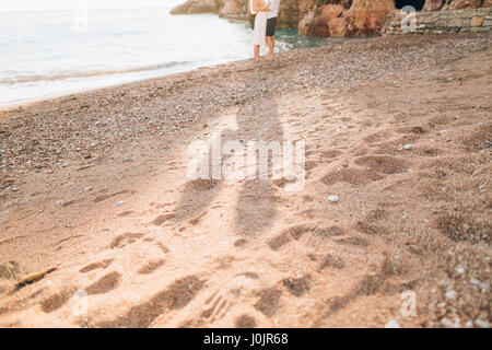 A shadow of a couple on the floor near the sea. The shadow of the newlyweds near the sea. Montenegro, the Adriatic. Stock Photo