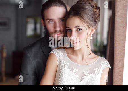 Portrait of the bride and groom close-up looking at the camera. Horizontal photo Stock Photo