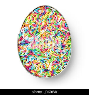 Colorful candy sprinkles in cutter in shape of egg on white background. Top view Stock Photo