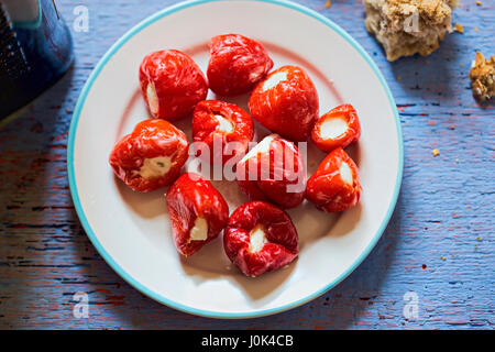 Peppers stuffed with feta cheese on white plate Stock Photo