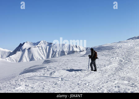 Skier on top of ski slope at nice morning. Caucasus Mountains, Georgia, ski resort Gudauri. Stock Photo