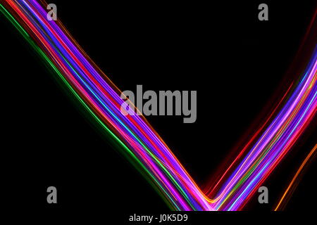 Long exposure photograph of neon multi-colour in an abstract pattern against a black background. Light painting photography, abstract colour Stock Photo