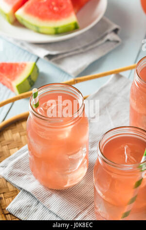 Refreshing Cold Watermelon Juice with Ice and a Straw Stock Photo