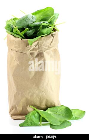fresh spinach in a paper bag isolated on white background Stock Photo