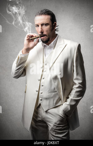 Elegant man smoking cigar Stock Photo