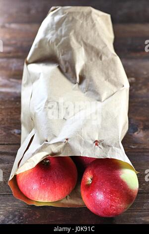 apples (variety Elstar) in a paper bag on wooden background Stock Photo