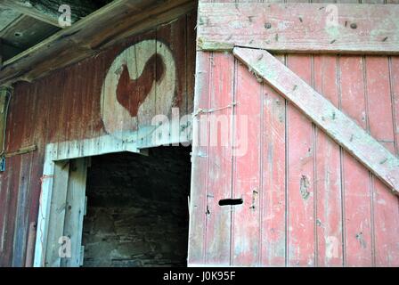 Open stable door with chicken emblem Stock Photo