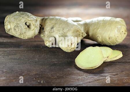 ginger rhizome on wooden background Stock Photo