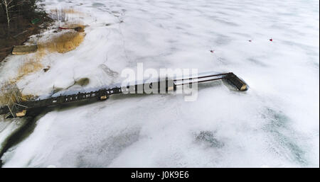 Aerial of a broken pier, between ice, on a winter day, in Westend, Espoo, Finland Stock Photo