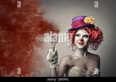 Clown woman with paint brush Stock Photo