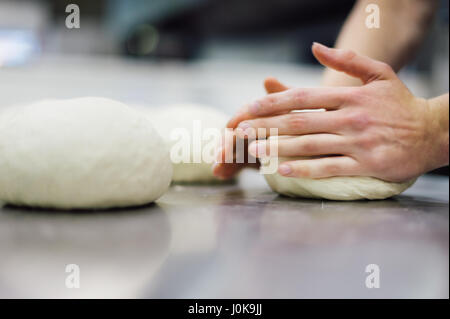 Baker Kneading Fresh Dough Stock Photo