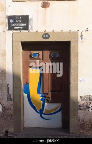 A painting of  face; part of a series of painted doorways from the "Art of Open Doors" project, Funchal, Madeira Stock Photo