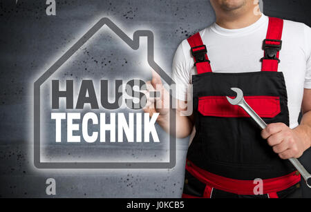 Haustechnik (in german House technology) with house touchscreen is operated by technician. Stock Photo