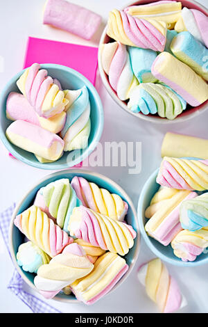 Twisted colourful marshmallows in paper cups Stock Photo
