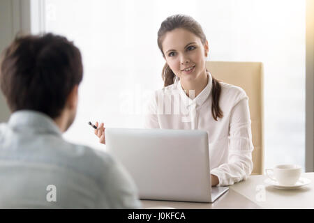 Smiling businesswoman interviewing a job applicant, business mee Stock Photo