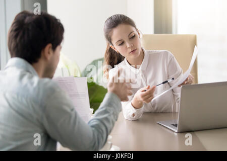 Conversation between businesswoman and businessman about documen Stock Photo