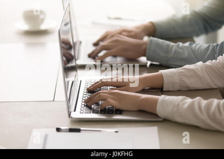 Male and female hands on keyboard, working on laptop, closeup Stock Photo