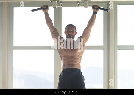 Athlete Performing Hanging Leg Raises Exercise - One Of The Most Effective Ab Exercises Stock Photo