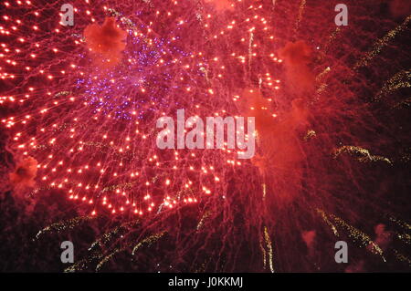 Red colorful fireworks on the black sky background Stock Photo