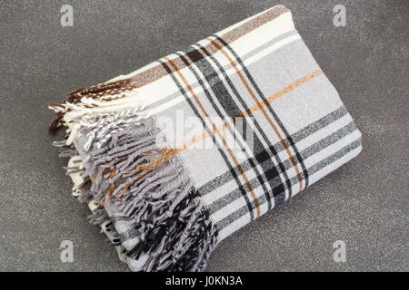 Plaid woolen in cage on gray background. Studio Photo Stock Photo