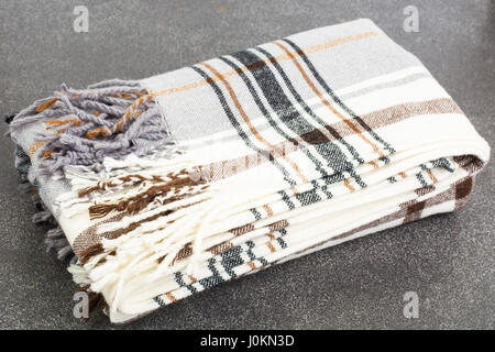 Plaid woolen in cage on gray background. Studio Photo Stock Photo