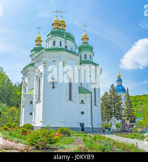 KIEV, UKRAINE - MAY 2, 2016: Saint George Cathedral is the central building in Vydubychi Monastery complex located among beautiful flower beds, on May Stock Photo