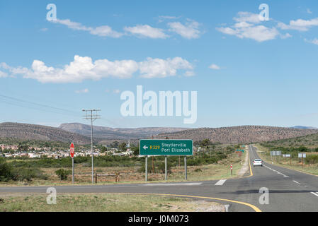 WILLOWMORE, SOUTH AFRICA - MARCH 23, 2017: Road signs on the N9 road at Willowmore with the name and founding date of the town written with white ston Stock Photo