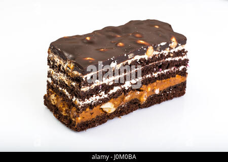 Chocolate caramel cake with nuts and whipped cream on white background. Studio Photo Stock Photo