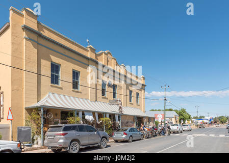 WILLOWMORE, SOUTH AFRICA - MARCH 23, 2017: An historic old building in Willowmore, with a group of bikers in front of a restaurant Stock Photo