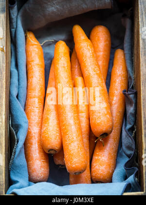 Carrots in a rustic wooden box. Stock Photo