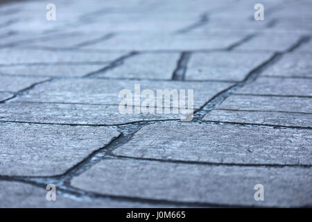 Macro grey cobbled pavers with soft focus background Stock Photo