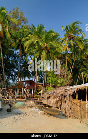 Sand tropical beach with coconut trees and traditional boat - Palolem beach, Goa, India Stock Photo