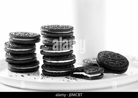 Oreo chocolate cookies stacked, served milk Stock Photo