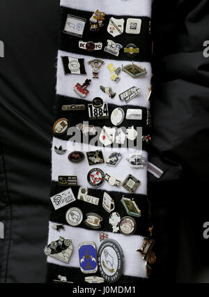 A Derby County supporter wearing a scarf covered in pin badges during the Sky Bet Championship match at Griffin Park, London. PRESS ASSOCIATION Photo. Picture date: Friday April 14, 2017. See PA story SOCCER Brentford. Photo credit should read: Paul Harding/PA Wire. RESTRICTIONS: EDITORIAL USE ONLY No use with unauthorised audio, video, data, fixture lists, club/league logos or 'live' services. Online in-match use limited to 75 images, no video emulation. No use in betting, games or single club/league/player publications. Stock Photo