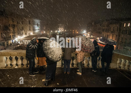 People at Rialto Bridge during an heavy snow fall in Venice. Stock Photo