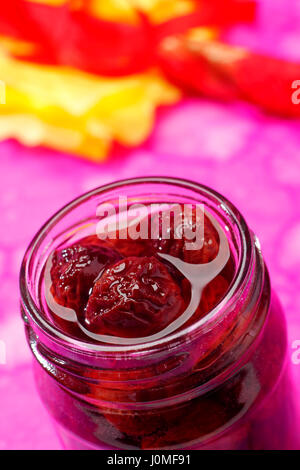 Sour cherry jam in opened screw-top jar Stock Photo