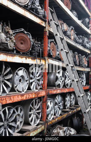 Wheel rims and car transmissions on shelves for resale Stock Photo