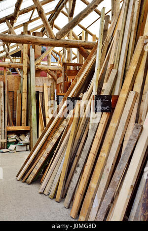Old used timber stacked for resale and recycled reuse Stock Photo