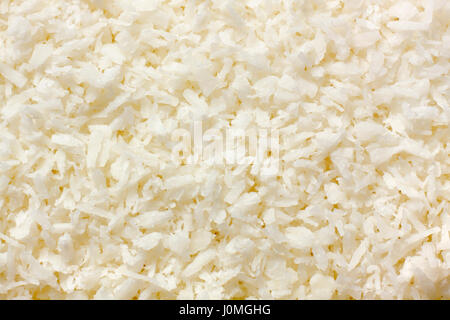 Grated coconut kernel (copra) close-up. Full frame, top view. Stock Photo