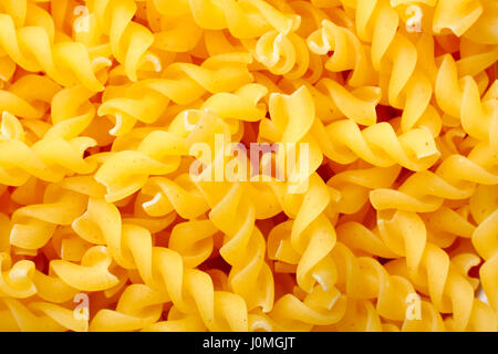 Raw rotini pasta. Full frame, top view. Stock Photo