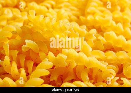 Raw rotini pasta. Full frame, close up view. Stock Photo