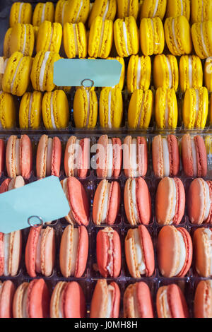 French macaron yellow and pink in row on tray Stock Photo