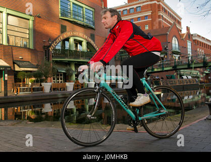 Paul Hudson on his bike in Birmingham in front of the Town Hall and riding along the canals. Stock Photo