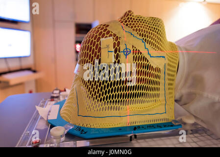 Patient Radiation therapy mask showing laser lines for targeting cancer cells in the brain Stock Photo