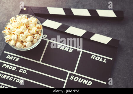 popcorn and movie maker on black table background Stock Photo