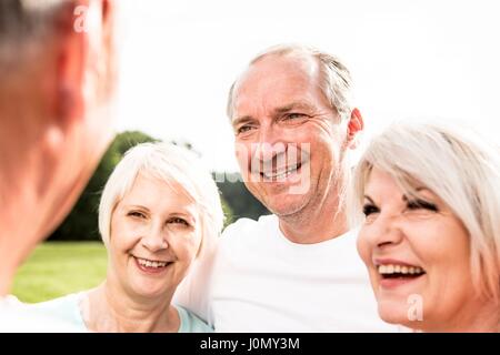 Four people smiling, portrait. Stock Photo